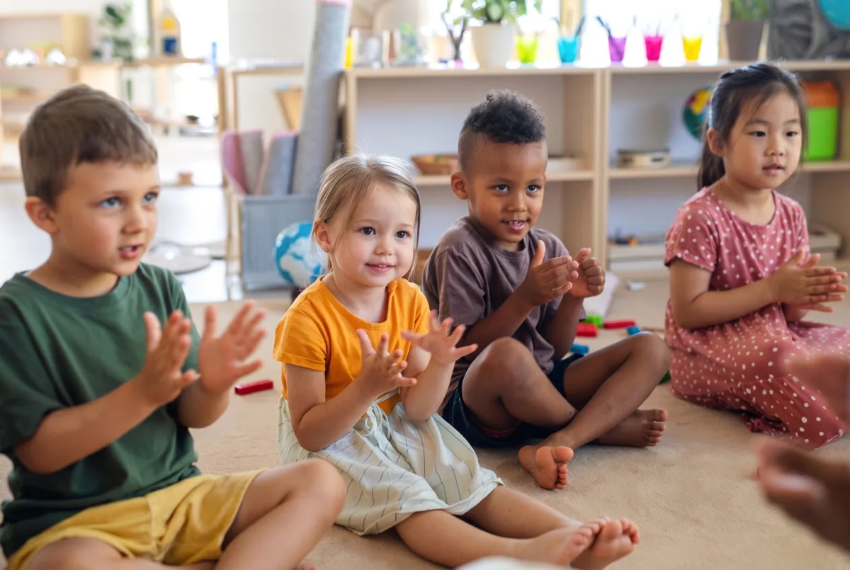 Young children clapping and learning rhythm in a Childhood Music Program class