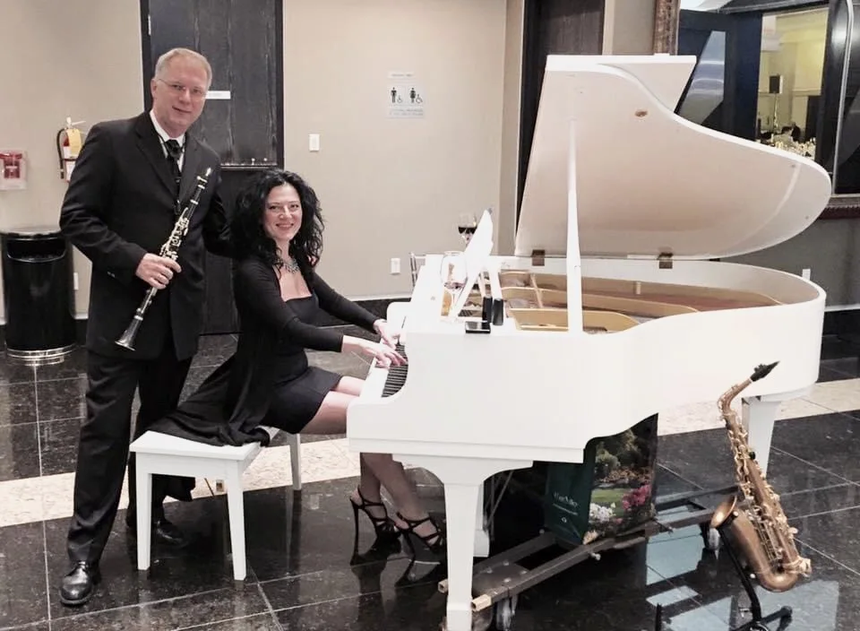 Anahit at a white grand piano with fellow musician