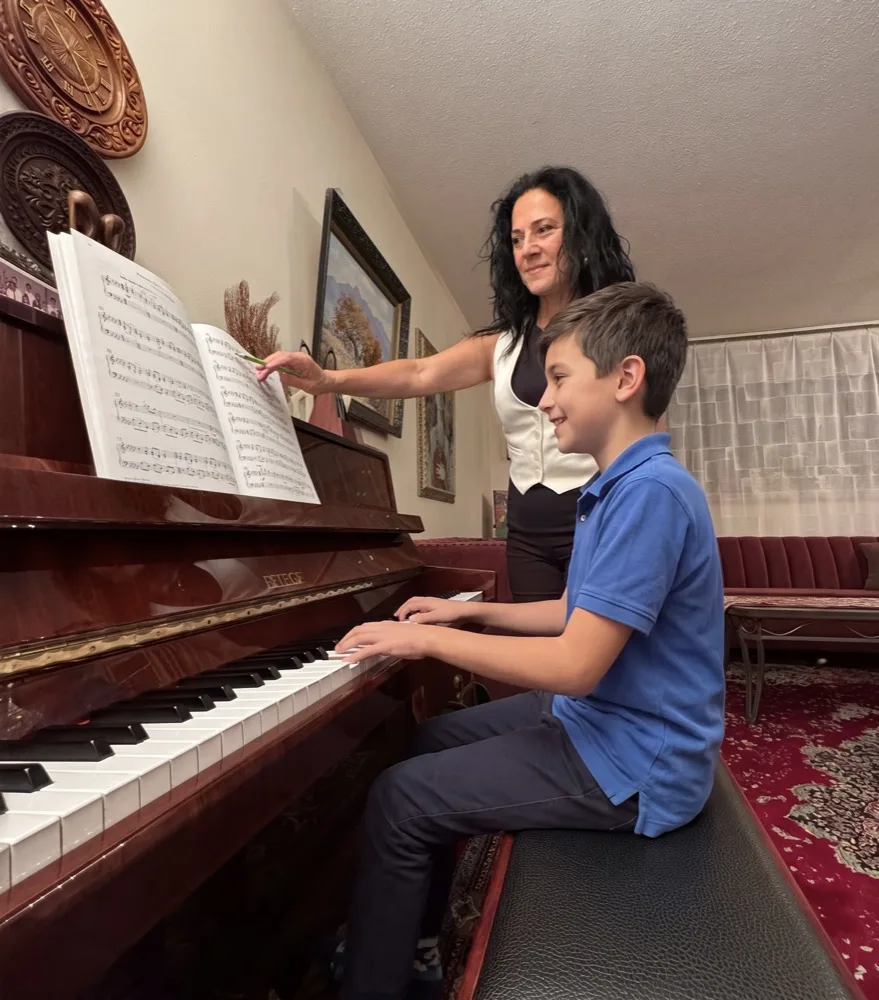 Anahit teaching a young student at the piano
